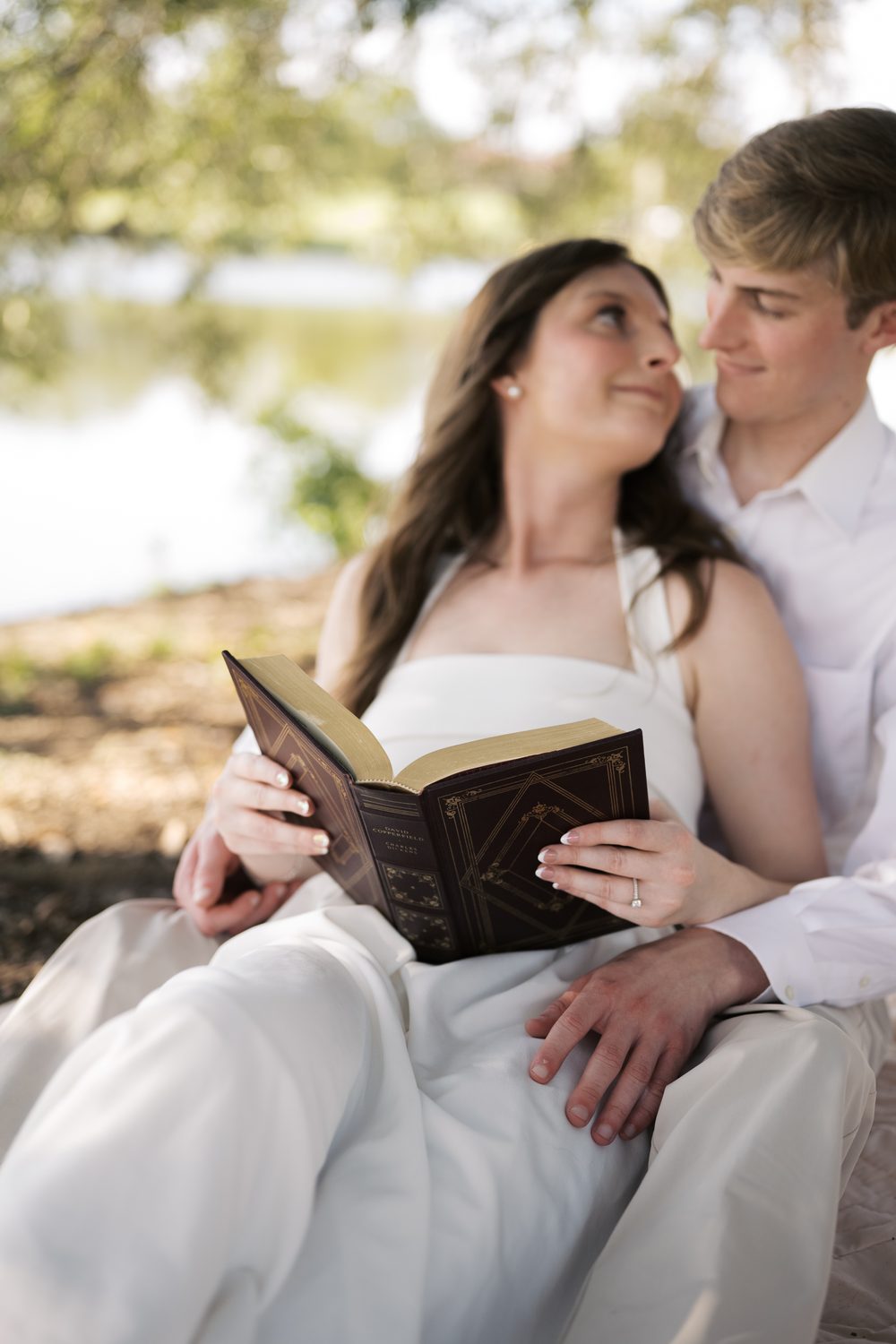 Ashlyn's engagement ring resting on an open book as she and Colton read together.