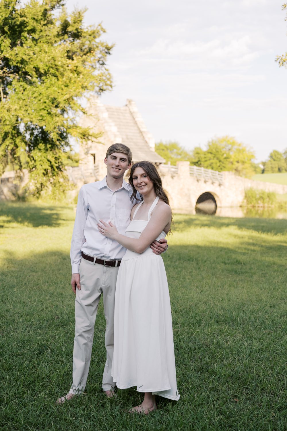 Colton and Ashlyn standing in front of a stone bridge.